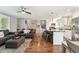 Open-concept living space with kitchen, cozy seating, hardwood floors, and natural light at 1713 S Holland St, Lakewood, CO 80232