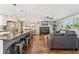 Spacious living area featuring a stone fireplace, comfortable seating, and seamless kitchen access at 1713 S Holland St, Lakewood, CO 80232