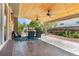 Spacious outdoor patio with a wood ceiling, ceiling fans, and ample seating at 1713 S Holland St, Lakewood, CO 80232