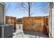 Backyard deck with fence and exterior AC unit in a fenced backyard at 1811 S Quebec Way # 60, Denver, CO 80231