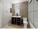 Modern bathroom with tiled accent wall, floating vanity, and glass enclosed shower at 1811 S Quebec Way # 60, Denver, CO 80231