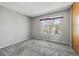 Neutral bedroom with a window providing natural light, and soft, patterned carpeting at 1811 S Quebec Way # 60, Denver, CO 80231