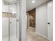 Hallway featuring a shower with stone accents and a view toward an accent wall at 1811 S Quebec Way # 60, Denver, CO 80231