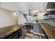 Kitchen showcasing stainless steel appliances, island cooktop, and modern fixtures at 1811 S Quebec Way # 60, Denver, CO 80231