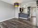 Open kitchen and dining area with modern light fixture and stylish gray accents at 1811 S Quebec Way # 60, Denver, CO 80231