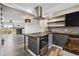 Kitchen with stainless steel appliances, gray cabinetry, and island cooktop at 1811 S Quebec Way # 60, Denver, CO 80231
