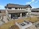 Spacious backyard featuring an outdoor seating area with a fireplace, outdoor grill, and manicured lawn at 3422 W 155Th Ave, Broomfield, CO 80023