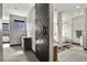 A modern bathroom with walk-in shower with glass door, freestanding tub, and sliding barn door at 3422 W 155Th Ave, Broomfield, CO 80023