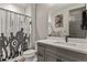 Bathroom featuring modern gray vanity with white countertop and a fun superhero shower curtain at 3422 W 155Th Ave, Broomfield, CO 80023