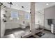 Luxurious bathroom showcasing a glass-enclosed shower with rain showerhead, marble tile walls, and a built-in bench at 3422 W 155Th Ave, Broomfield, CO 80023