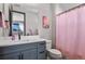 Bright bathroom featuring a gray vanity with white countertop and a colorful shower curtain at 3422 W 155Th Ave, Broomfield, CO 80023