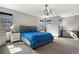 This bedroom features a comfortable bed with bright blue linens, a modern light fixture, and lots of natural light at 3422 W 155Th Ave, Broomfield, CO 80023