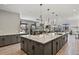 Spacious kitchen with island with seating area, seamlessly flowing into the living and dining spaces at 3422 W 155Th Ave, Broomfield, CO 80023