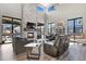 Inviting living room with a stone fireplace, large windows, and comfortable seating arrangement at 3422 W 155Th Ave, Broomfield, CO 80023