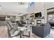 Inviting living room with a stone fireplace, large windows, and comfortable seating area, perfect for relaxing at 3422 W 155Th Ave, Broomfield, CO 80023