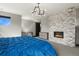 Inviting main bedroom boasts a stylish stone fireplace, modern light fixture, and neutral color scheme at 3422 W 155Th Ave, Broomfield, CO 80023