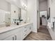 Modern bathroom boasts a double sink vanity with quartz countertop, sleek fixtures, and a separate shower at 485 Interlocken Blvd # 106, Broomfield, CO 80021