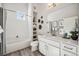 Modern bathroom with white tiled shower, vanity, storage, and neutral decor, complete with bright light at 485 Interlocken Blvd # 106, Broomfield, CO 80021