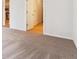 Spacious carpeted bedroom with an entry to the kitchen and bathroom at 485 Interlocken Blvd # 106, Broomfield, CO 80021