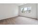 Bright bedroom with large window and carpeted floor at 485 Interlocken Blvd # 106, Broomfield, CO 80021