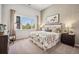 Bright bedroom featuring a large window with scenic views, stylish decor, and neutral color palette at 485 Interlocken Blvd # 106, Broomfield, CO 80021