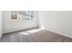 Sunlit room with neutral carpet and view of the outside community at 485 Interlocken Blvd # 106, Broomfield, CO 80021