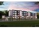 Modern apartment building featuring a combination of gray and dark blue exterior and well-maintained green lawn at 485 Interlocken Blvd # 106, Broomfield, CO 80021