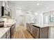 Modern kitchen featuring stainless steel appliances, a kitchen island, and wood flooring at 485 Interlocken Blvd # 106, Broomfield, CO 80021
