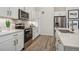 Bright kitchen featuring stainless steel appliances, white cabinets, and countertops with modern finishes at 485 Interlocken Blvd # 106, Broomfield, CO 80021