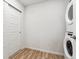 A laundry room featuring a stacked washer and dryer set and a sliding door for storage at 485 Interlocken Blvd # 106, Broomfield, CO 80021