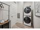 Compact laundry room with stacked washer and dryer, ample storage, and practical design at 485 Interlocken Blvd # 106, Broomfield, CO 80021