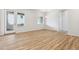 Spacious living room featuring wood flooring, bright windows, and a door to an outdoor deck at 485 Interlocken Blvd # 106, Broomfield, CO 80021