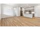 Spacious living room area with wood flooring, modern lighting and an open concept to the kitchen at 485 Interlocken Blvd # 106, Broomfield, CO 80021