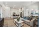 Open concept living space with modern kitchen, comfortable seating, and light-filled ambiance under bright light at 485 Interlocken Blvd # 106, Broomfield, CO 80021