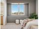 A modern bedroom with vertical wall panelling and a view of the city skyline through a large window at 2326 Eliot St # 7, Denver, CO 80211