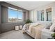 Modern bedroom with a paneled accent wall, neutral decor, large windows, and plush bedding at 2326 Eliot St # 7, Denver, CO 80211