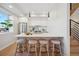 Kitchen island with barstool seating, white countertops, wooden cabinets, and stainless steel appliances at 2326 Eliot St # 7, Denver, CO 80211