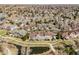 Scenic aerial shot of homes with a pond, walking trails, and lush landscaping, creating a peaceful neighborhood at 6024 W Colorado Ln, Lakewood, CO 80232