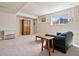 Basement area with carpeted floors, furniture, storage cabinet and natural light at 6024 W Colorado Ln, Lakewood, CO 80232