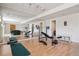 Basement gym area with wood flooring, exercise equipment and mirrored walls at 6024 W Colorado Ln, Lakewood, CO 80232