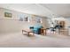 Spacious finished basement featuring carpeted floors, natural light, and an exercise area at 6024 W Colorado Ln, Lakewood, CO 80232