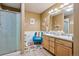 Bright bathroom with double vanity, glass-enclosed shower, and stylish decor at 6024 W Colorado Ln, Lakewood, CO 80232