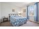 Serene bedroom featuring a comfortable bed, soft carpet, and a bright window with a view at 6024 W Colorado Ln, Lakewood, CO 80232