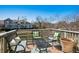 Relaxing deck overlooking a tranquil pond, complete with stylish outdoor furniture and decorative pillows at 6024 W Colorado Ln, Lakewood, CO 80232