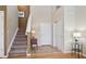Inviting entryway with wood floors, tiled inlay, staircase, and a convenient coat closet at 6024 W Colorado Ln, Lakewood, CO 80232