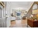 Inviting entryway flows into a bright living room with large windows and hardwood floors, with a view of the staircase at 6024 W Colorado Ln, Lakewood, CO 80232