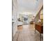 Inviting entryway flows into a bright living room with large windows and hardwood floors, with a view of the staircase at 6024 W Colorado Ln, Lakewood, CO 80232