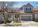 Charming two-story townhome with a well-maintained front yard and attached two-car garage on a sunny day at 6024 W Colorado Ln, Lakewood, CO 80232