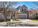Charming two-story home featuring a large front-facing garage, neutral toned siding, and well-kept front yard at 6024 W Colorado Ln, Lakewood, CO 80232