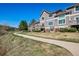 Exterior of townhomes with private balconies and landscaped yard with walking path at 6024 W Colorado Ln, Lakewood, CO 80232